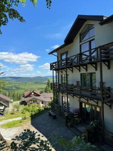 a house with balconies on the side of it at DACHA на Магурі in Pilipets