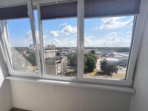 a window in a room with a view of a city at Sky View in Marijampolė