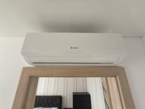 a white ceiling in a living room with a tv at Sky View in Marijampolė