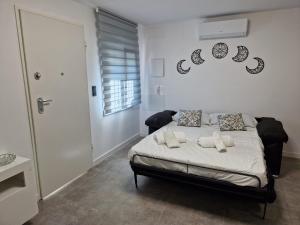 a bedroom with a bed with two pillows on it at House totally refurbished in 2024, terrace in front of the sea, 1 min walk to the beach, aircon, wifi in Alicante