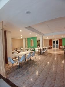a dining room with tables and chairs in a building at Hotel Luis III in Mar del Plata