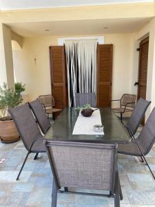 a table and chairs in a living room at Eleni's Guest House in Patitiri +36 photos