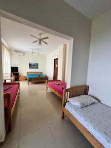 a bedroom with three beds and a living room at Villa Filip in Vuno