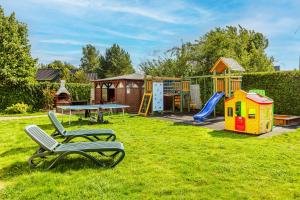 a yard with a chair and a playground at Willa Wilk Morski in Jastrzębia Góra