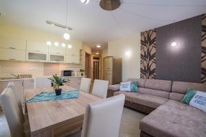 a kitchen and dining room with a table and a couch at ★ BB Wellness Apartman ★ in Siófok