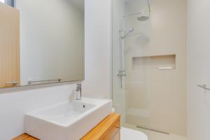 a white bathroom with a sink and a shower at Cristiano Ronaldo Airport View in Santa Cruz +13 photos