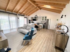 a living room with a couch and a table at Quinta do Planalto Vicentino - Casas de Campo in Aljezur