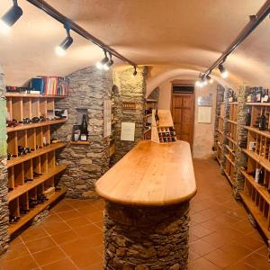 a room with a wooden counter in a wine cellar at Locanda La Clusaz in Gignod
