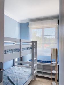 a bedroom with two bunk beds and a window at Chez Anabelle et Damien in Antibes +12 photos