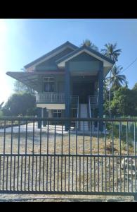 a house with a fence in front of it at SH Homestay in Kota Bharu