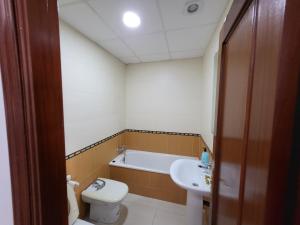 a bathroom with a tub and a toilet and a sink at Casa Andrea in Puerto Real