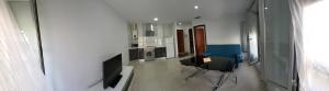 a room with two chairs and a television in it at Casa Andrea in Puerto Real