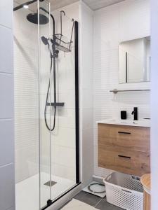 a white bathroom with a shower and a sink at Chez Anabelle et Damien in Antibes