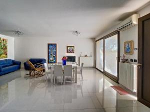 a living room with a table and a blue couch at Terra Bianca Salento in Nardò