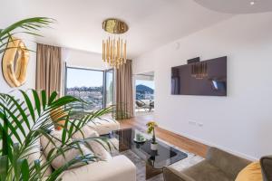a living room with a couch and a plant at Villa Sunset Dubrovnik in Dubrovnik