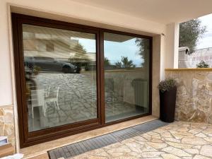 a sliding glass door of a house with a patio at Terra Bianca Salento in Nardò +38 photos