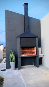 a outdoor fireplace with a brick oven at Belize Apart in San José +26 photos