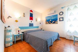 a bedroom with a bed in a room with a lighthouse at Villa Tiziana in Costa Rei