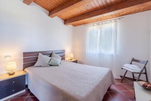 a bedroom with a large bed and a window at Estremo Sud - Marzamemi Candy in Marzamemi