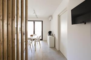 a dining room with a table and a tv on a wall at Visitsicilia Vasile 9 in Castellammare del Golfo