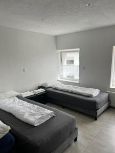 Postel nebo postele na pokoji v ubytování Ferienhaus Zum Heilbrunnen + 7 fotografií