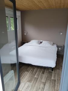 a bedroom with a white bed and a mirror at Terres de France - Le Domaine du Moulin Neuf in Rochefort-en-Terre +32 photos