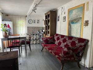 a living room with a red couch and a table at OK Sahli in Shekhvetili