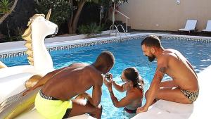a group of three people in a swimming pool at Bayside Concha House - Beachfront Oasis with Heated Pool in Playa Honda