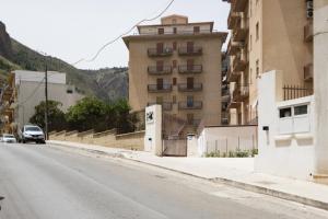 an empty street with a building in the background at Visitsicilia Vasile 9 in Castellammare del Golfo
