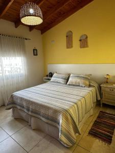a bedroom with a large bed in a room at Departamento Diag Buenos Aires 55 in Capilla del Monte