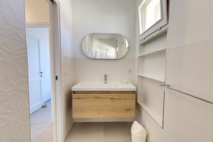a bathroom with a sink and a mirror at Porto Ottiolu Resort in Porto Ottiolu +50 photos