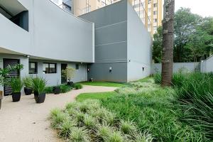 an external view of a building with plants at Easy Emiliano - Apartamentos UROOMS in Curitiba