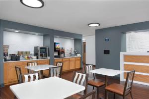a restaurant with white tables and chairs and a counter at Stay 2Night Chattanooga Hamilton Place in Chattanooga