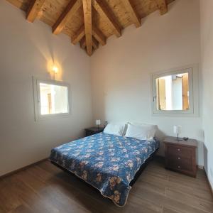 a bedroom with a bed and two windows at Castello Mountain Lake Iseo Hospitaty in Bossico