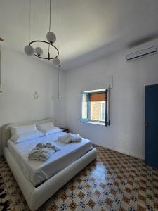 Rúm í herbergi á Terra Muronis Hotel Diffuso