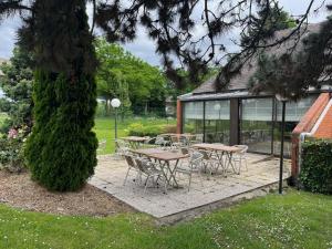 a group of tables and chairs in a garden at Campanile Lille Sud - CHR in Lille