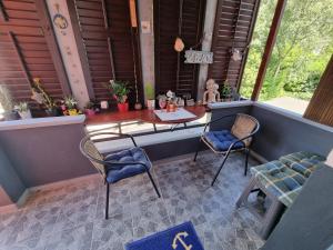 a porch with a table and two chairs and a table at SubCastrum Apartments in Pula