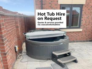 a trash can sitting next to a brick wall with a sign at South Beach Villa in Bridlington