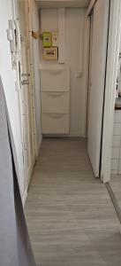 an empty corridor of a room with white walls and wood floors at Charmant Studio Cosy Confort in Alfortville +8 photos