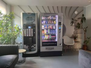a large vending machine with drinks in a room at City Hotel Bucharest in Bucharest