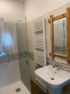 a bathroom with a sink and a shower at casa vacanze nigritella in Ornavasso +5 photos