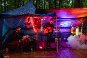 two men playing guitar in a tent at WisiLas Nad Sercowym Potokiem in Rabka-Zdrój