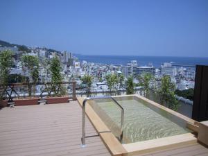 a swimming pool on the roof of a building at Shin Kadoya in Atami