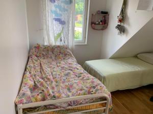 a small bedroom with a bed and a window at Villa Bliss in Surte