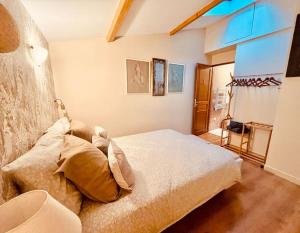 a bedroom with a large bed in a room at Bienvenue au Clos d Albertine in Lancié