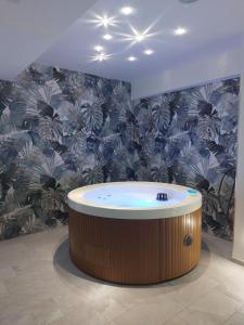 ein Whirlpool in einem Zimmer mit tropischer Tapete in der Unterkunft Residence Aurora Wellness & Spa in Albenga + 119 Fotos
