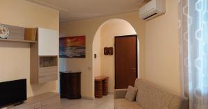 a living room with a couch and a tv at Appartamento b&b Villa Aroma in Mottella