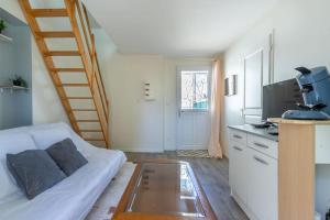 a living room with a couch and a coffee table at Maisonnette cosy proche des 2 Gares et du centre ville Orléans in Orléans