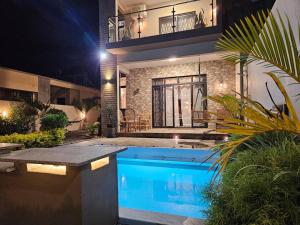 a house with a swimming pool at night at Villa Inaaya - Flic en Flac in Flic-en-Flac