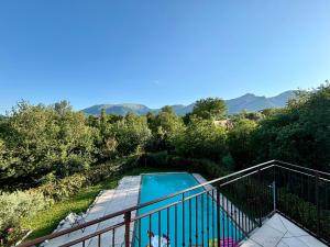 a view of a swimming pool from a balcony at Casa Vacanze Al Cielo 2 in Sarnano